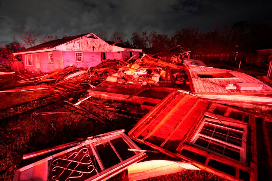 Destroyed homes, illuminated by fire engine lights, are seen after a tornado struck the area in Arabi, La., Tuesday, March 22, 2022. A tornado tore through parts of New Orleans and its suburbs Tuesday night, ripping down power lines and scattering debris in a part of the city that had been heavily damaged by Hurricane Katrina 17 years ago. (AP Photo/Gerald Herbert)