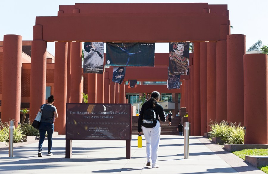 Students walk past the Harriet and Charles Luckman Fine Arts Complex at the Cal State University, Los Angeles campus on April 25, 2019. (AP Photo/Damian Dovarganes, File)