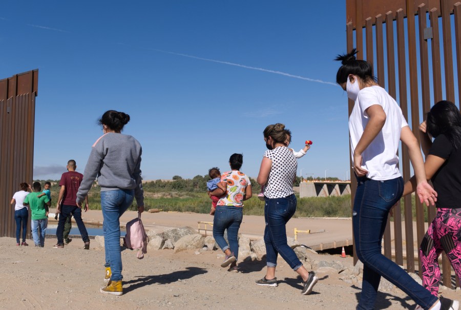 A group of Brazilian migrants make their way around a gap in the U.S.-Mexico border in Yuma, Ariz., seeking asylum in the United States after crossing over from Mexico, June 8, 2021. border. The Biden administration has unveiled new procedures to handle asylum claims at the U.S. southern border, hoping to decide cases in months instead of years. The rules empower asylum officers to grant or deny claims, an authority that has been limited to immigration judges for people arriving at the border with Mexico. (AP Photo/Eugene Garcia, File)