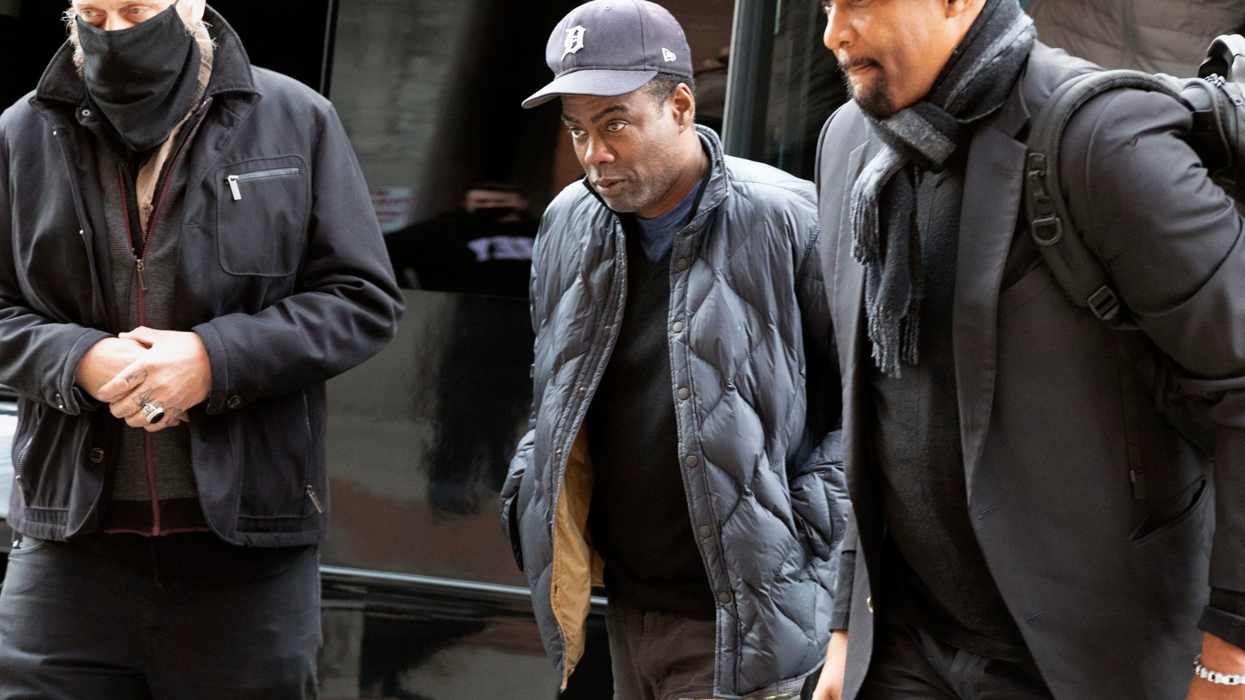 Chris Rock, center, arrives at the Wilbur Theater before a performance on March 30, 2022, in Boston. (AP Photo/Michael Dwyer)