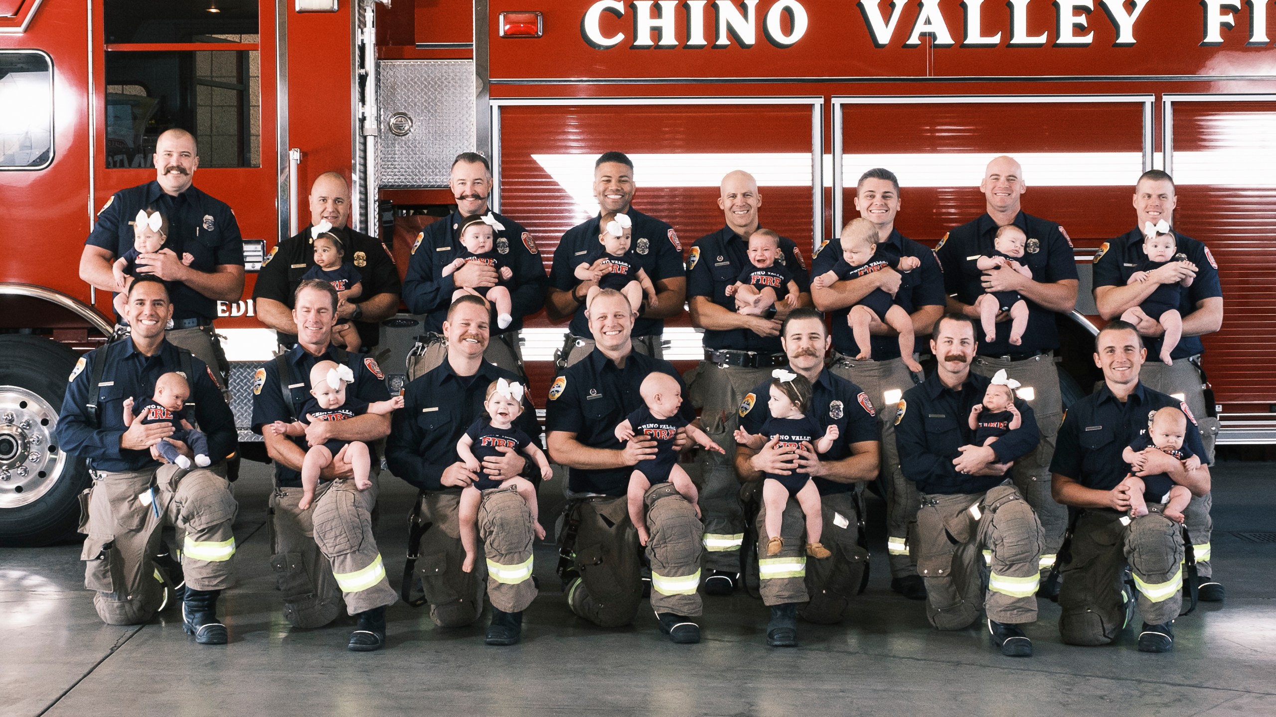 Firefighters at the Chino Valley Fire District posed with their babies in a photo shared by the agency on March 3, 2022.