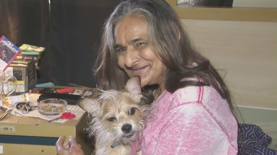 Sandra Martin and her dog, Little Man, are reunited in this March 16, 2022 image. (KTLA)