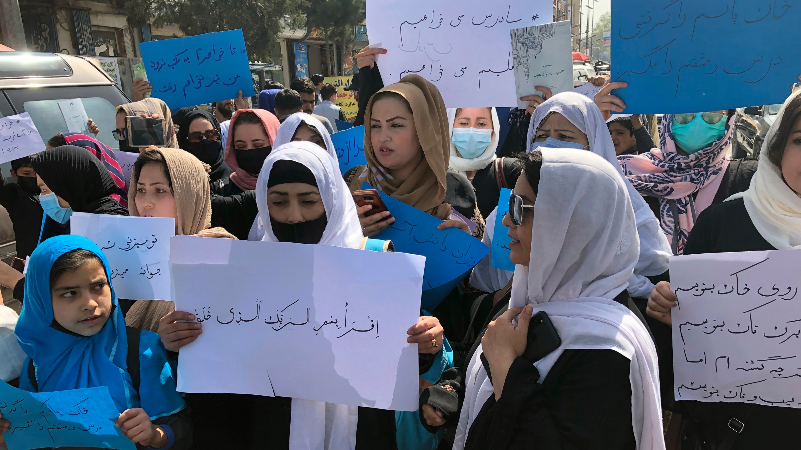 Afghan women chant and hold signs of protest during a demonstration in Kabul, Afghanistan, Saturday, March 26, 2022. Afghanistan's Taliban rulers refused to allow dozens of women to board several flights, including some overseas, because they were traveling without a male guardian, two Afghan airline officials said Saturday. (AP Photo/Mohammed Shoaib Amin)