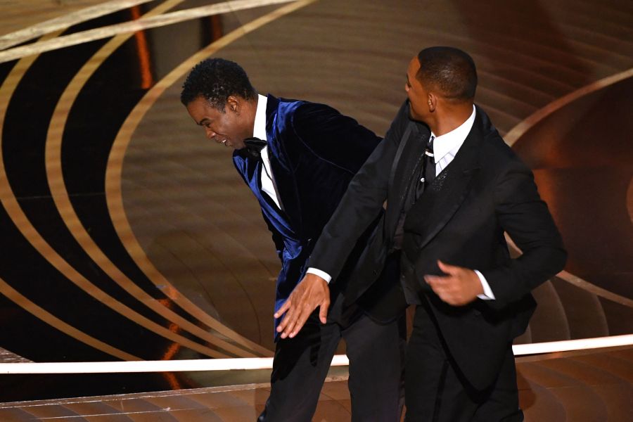 Actor Will Smith, right, slaps actor Chris Rock onstage during the 94th Oscars at the Dolby Theatre in Hollywood, California on March 27, 2022. (Robyn Beck / AFP via Getty Images)