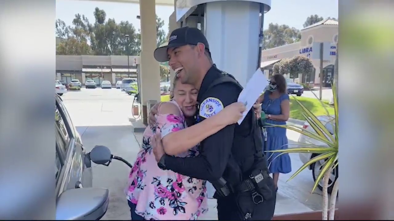 Officers with Oceanside Police Department were on a mission to help drivers with rising gas prices, handing out $50 bills to help drivers deal with pain at the pump on Tuesday, March 22, 2022. (KSWB)