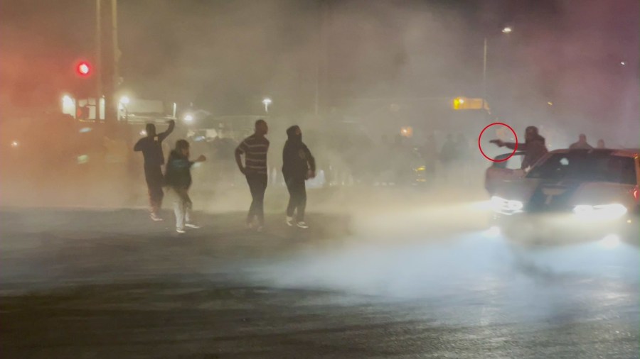 What appears to be a handgun is seen during a street takeover in South Los Angeles on March 21, 2022. (Credit: Anonymous videographer)