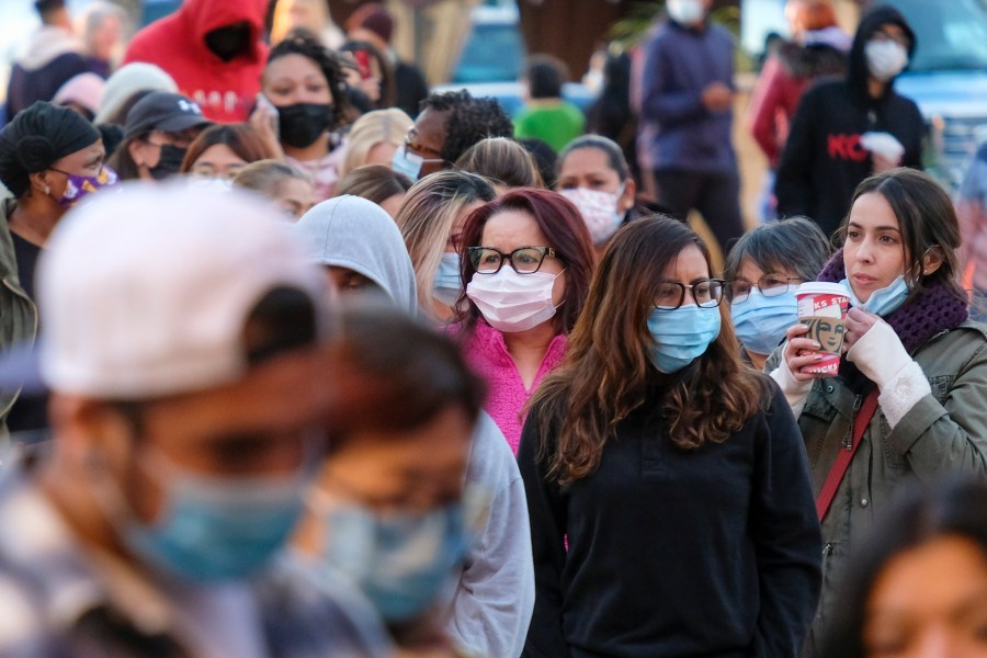 Shoppers wait in line to enter a store at the Citadel Outlets in Commerce on Friday, Nov. 26, 2021. (AP Photo/Ringo H.W. Chiu, File)