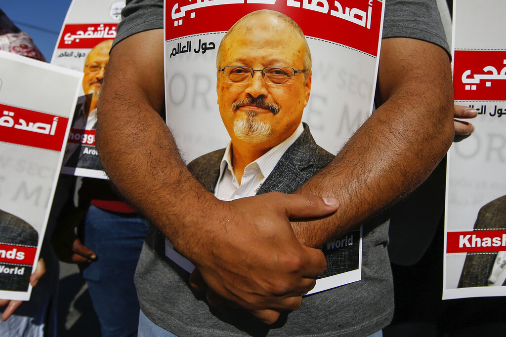 People hold posters of slain Saudi journalist Jamal Khashoggi, near the Saudi Arabia consulate in Istanbul, Oct. 2, 2020, marking the two-year anniversary of his death. (AP Photo/Emrah Gurel, File)