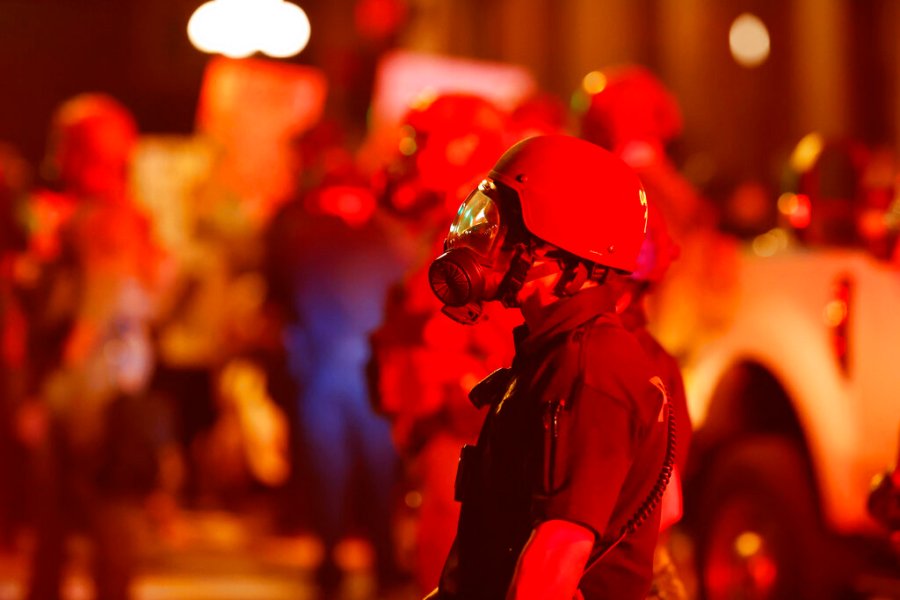 A Denver Police officer wears a gas mask before tear gas and rubber bullets were used to disperse protesters outside the State Capitol over the death of George Floyd, Thursday, May 28, 2020, in Denver. (AP Photo/David Zalubowski, File)