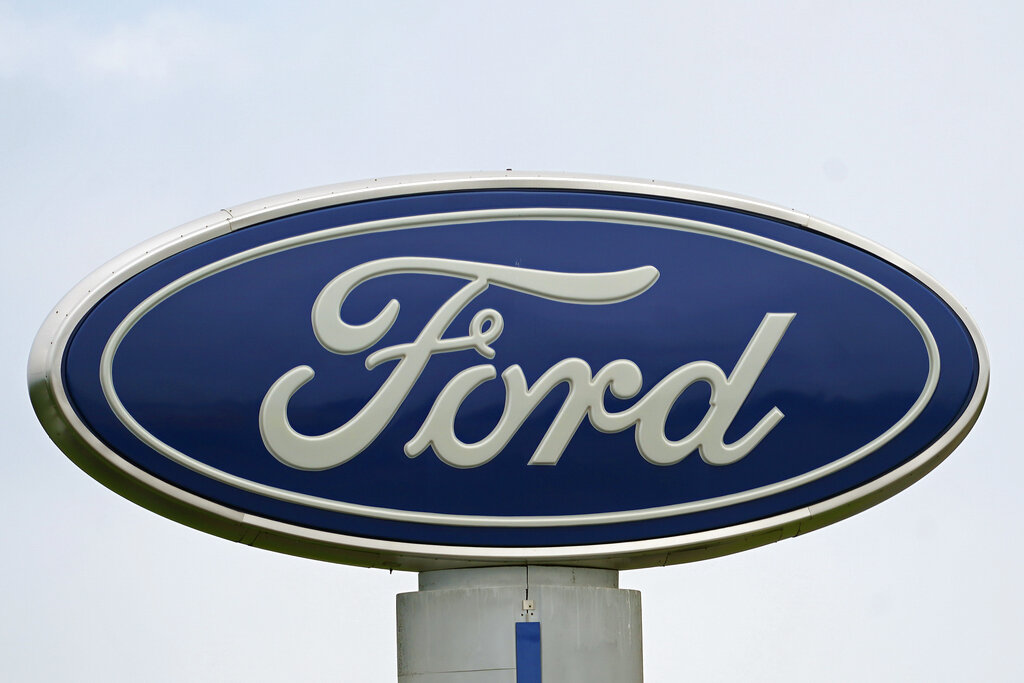 A Ford logo is seen on signage at Country Ford in Graham, N.C., Tuesday, July 27, 2021. (AP Photo/Gerry Broome, File)