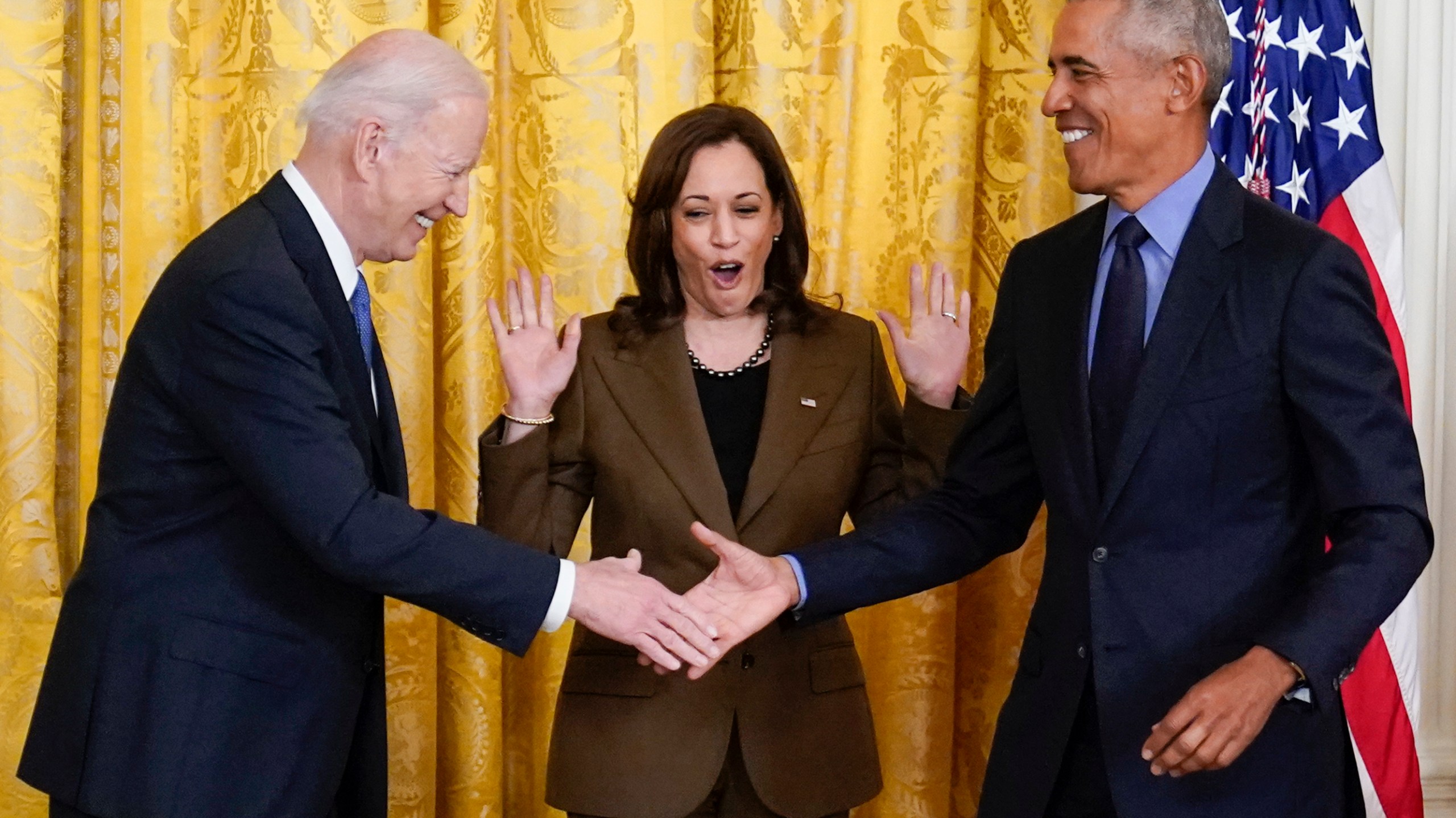 Vice President Kamala Harris reacts as President Joe Biden shakes hands with former President Barack Obama after Obama jokingly called Biden vice president in the East Room of the White House in Washington on April 5, 2022. (AP Photo/Carolyn Kaster)