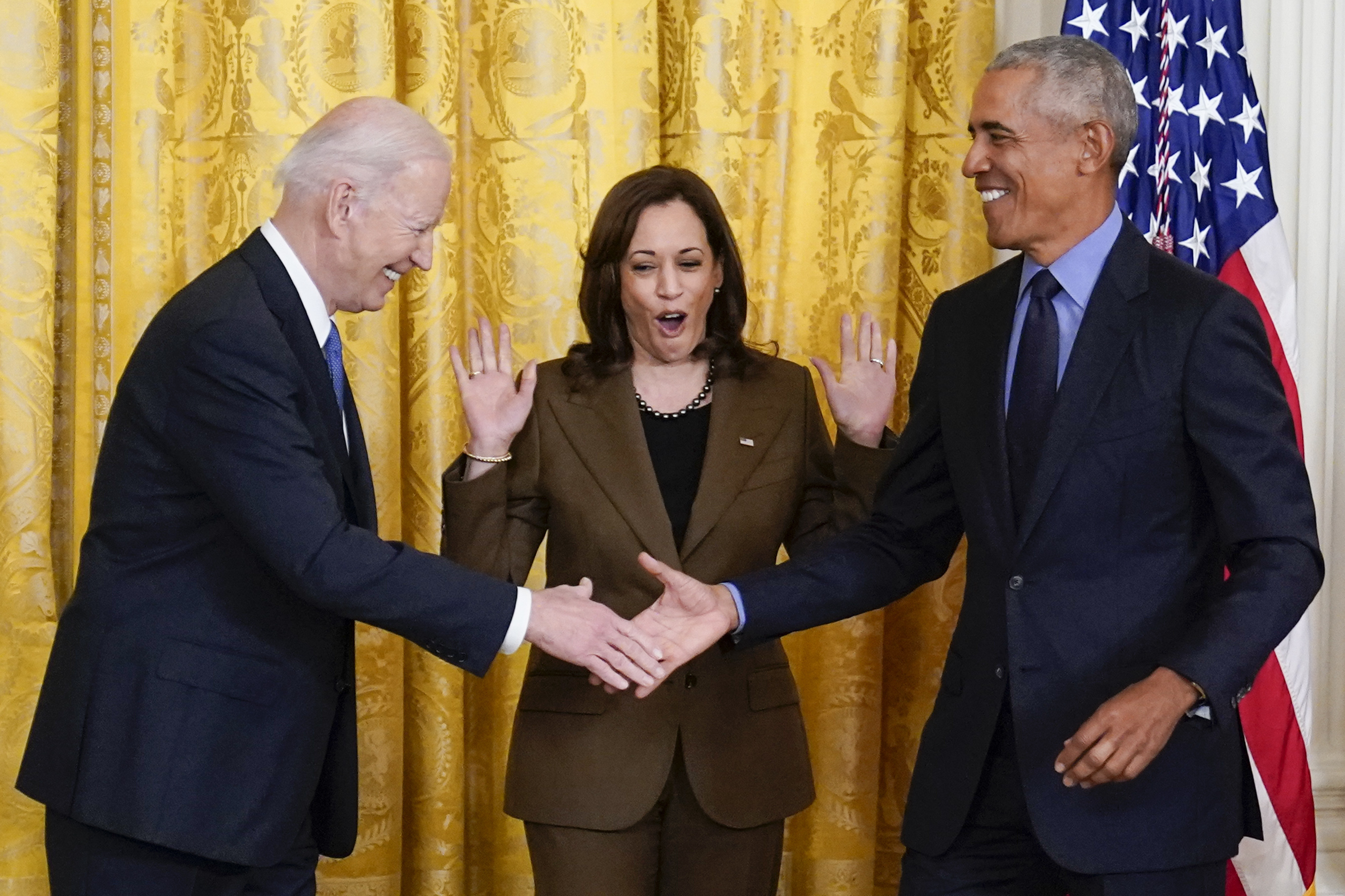 Vice President Kamala Harris reacts as President Joe Biden shakes hands with former President Barack Obama after Obama jokingly called Biden vice president in the East Room of the White House in Washington on April 5, 2022. (AP Photo/Carolyn Kaster)