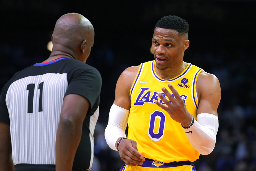 Los Angeles Lakers guard Russell Westbrook talks to referee Derrick Collins during the second half of the team's NBA basketball game against the Phoenix Suns, Tuesday, April 5, 2022, in Phoenix. (AP Photo/Rick Scuteri)