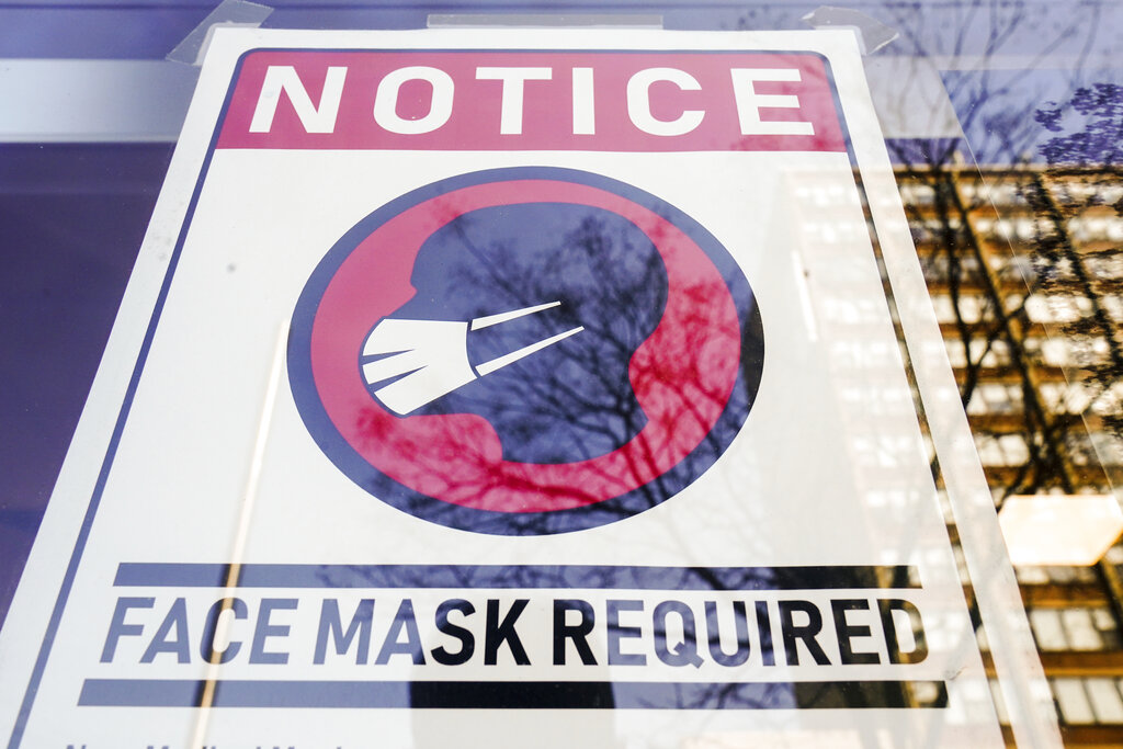 A sign requiring masks as a precaution against the spread of the coronavirus on a store front in Philadelphia, is seen Feb. 16, 2022. (AP Photo/Matt Rourke, File)