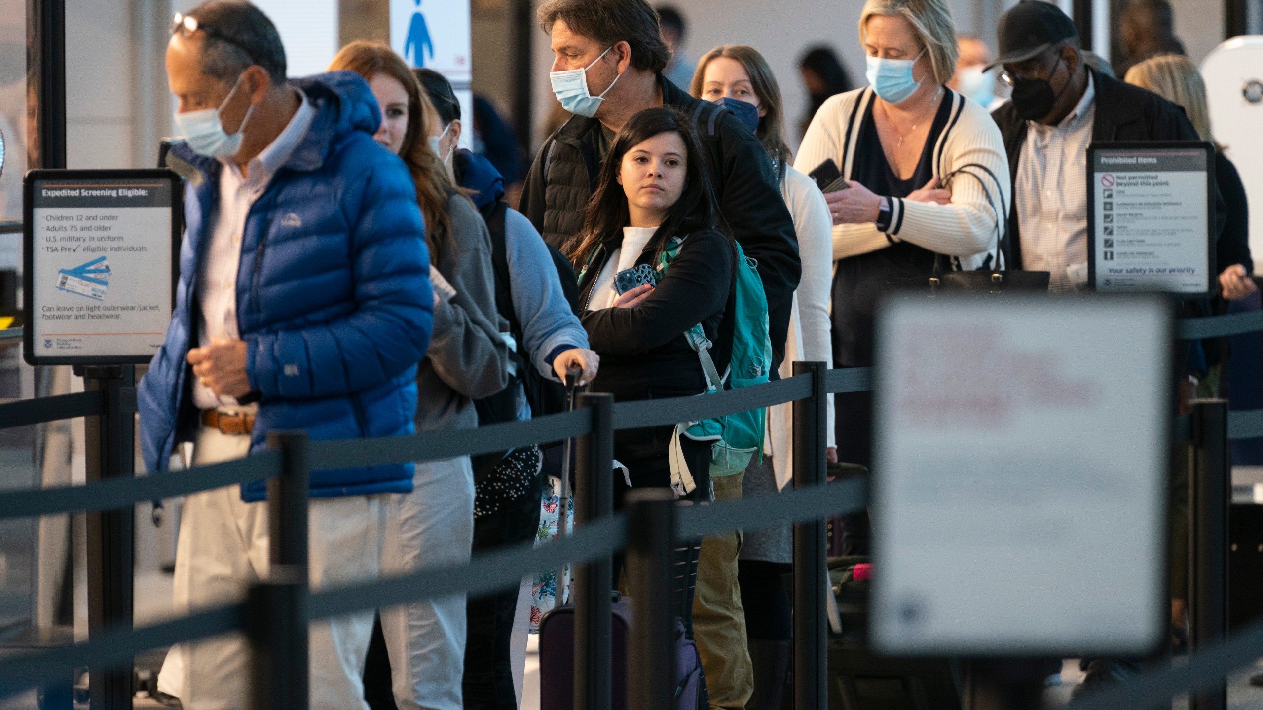 Passengers wait in line at the security checkpoint at Ronald Reagan Washington National Airport on April 19, 2022. (Evan Vucci/Associated Press)