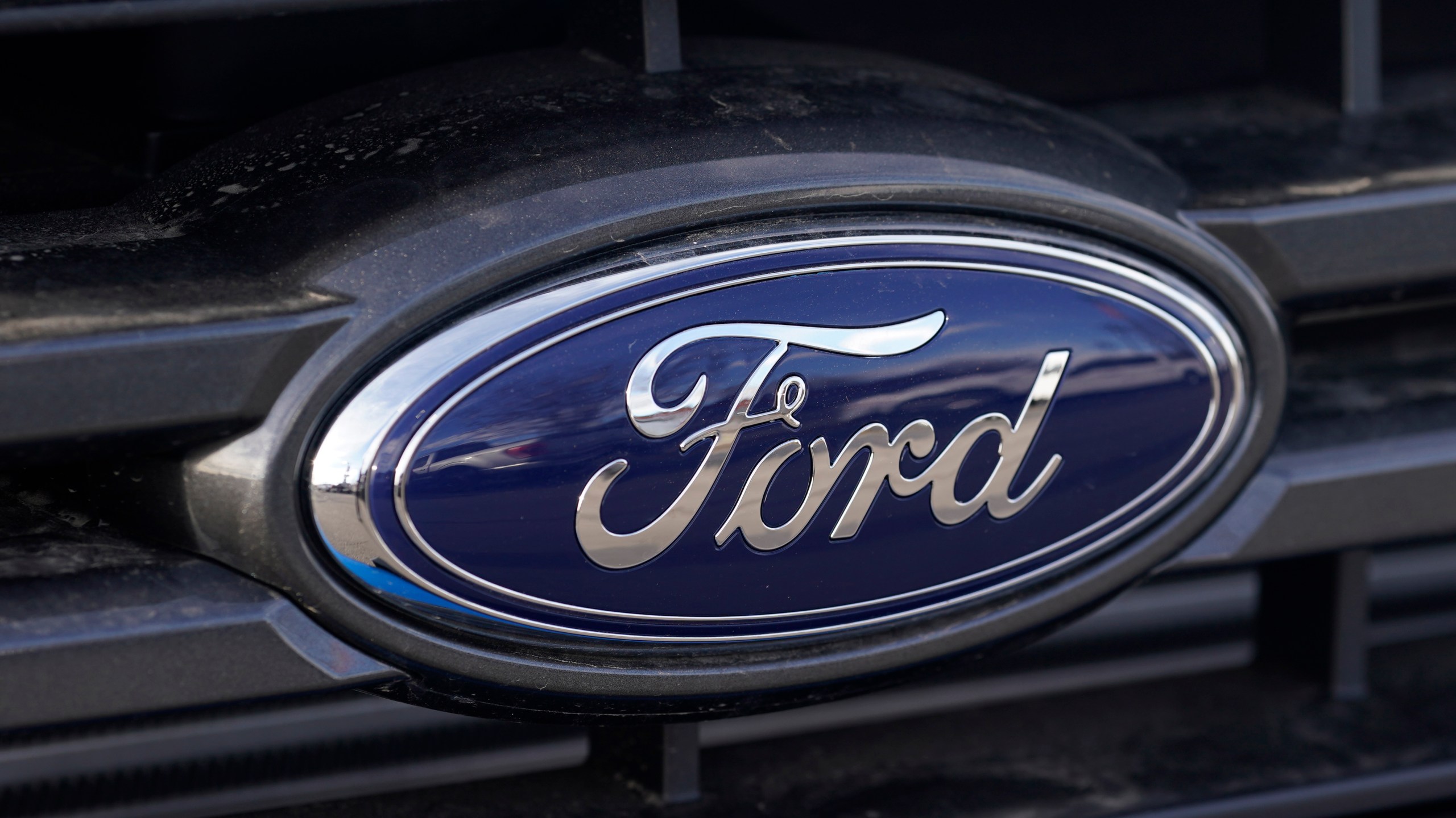 In this Sunday, April 25, 2021, photograph, the blue oval logo of Ford Motor Company is shown at a dealership in east Denver. (AP Photo/David Zalubowski, File)