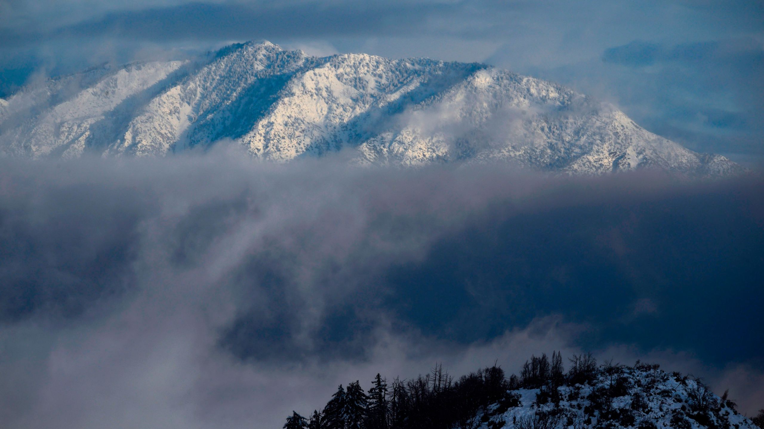 This file photo from Dec. 26, 2019 shows Mount Baldy covered in snow in the Angeles National Forest north of Los Angeles. (ROBYN BECK/AFP via Getty Images)