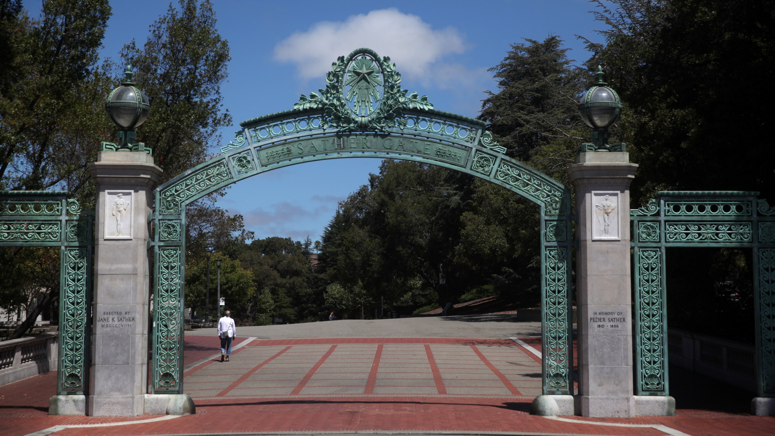 A lone pedestrian walks by Sather Gate on the U.C. Berkeley campus on July 22, 2020. (Justin Sullivan/Getty Images)