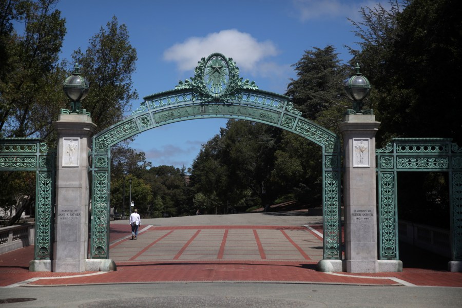 A lone pedestrian walks by Sather Gate on the U.C. Berkeley campus on July 22, 2020. (Justin Sullivan/Getty Images)