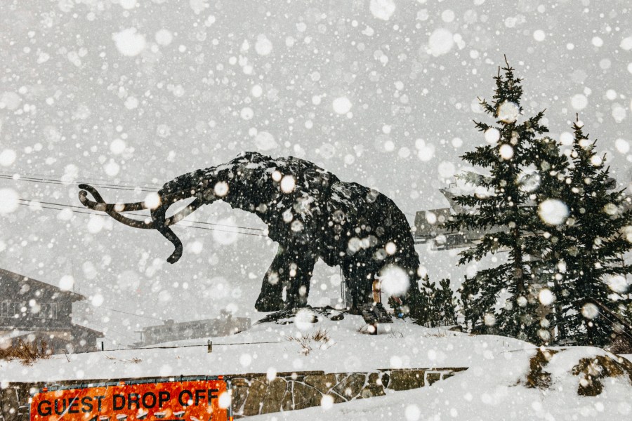 In this photo provided by Mammoth Mountain Ski Area, fresh snow falls in the guest drop-off area in Mammoth Mountain in Mammoth Lakes, Calif., on Friday, April 15, 2022. California storms have blanketed the Sierra Nevada in snow. Winter isn't quite ready to give up its grip on the Eastern Sierra. Mammoth Mountain is expecting a foot of fresh snow Saturday. (Peter Morning/MMSA via AP)