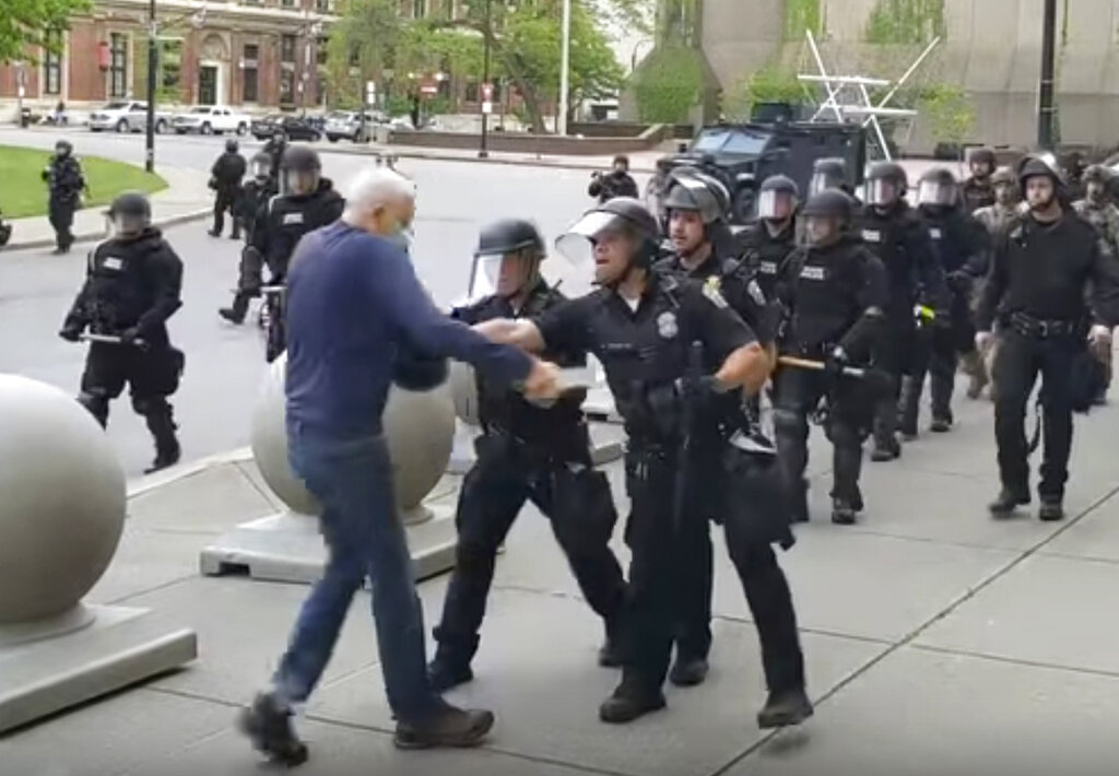 In this image from video provided by WBFO, a Buffalo police officer appears to shove a man who walked up to police Thursday, June 4, 2020, in Buffalo, N.Y. (Mike Desmond/WBFO via AP)