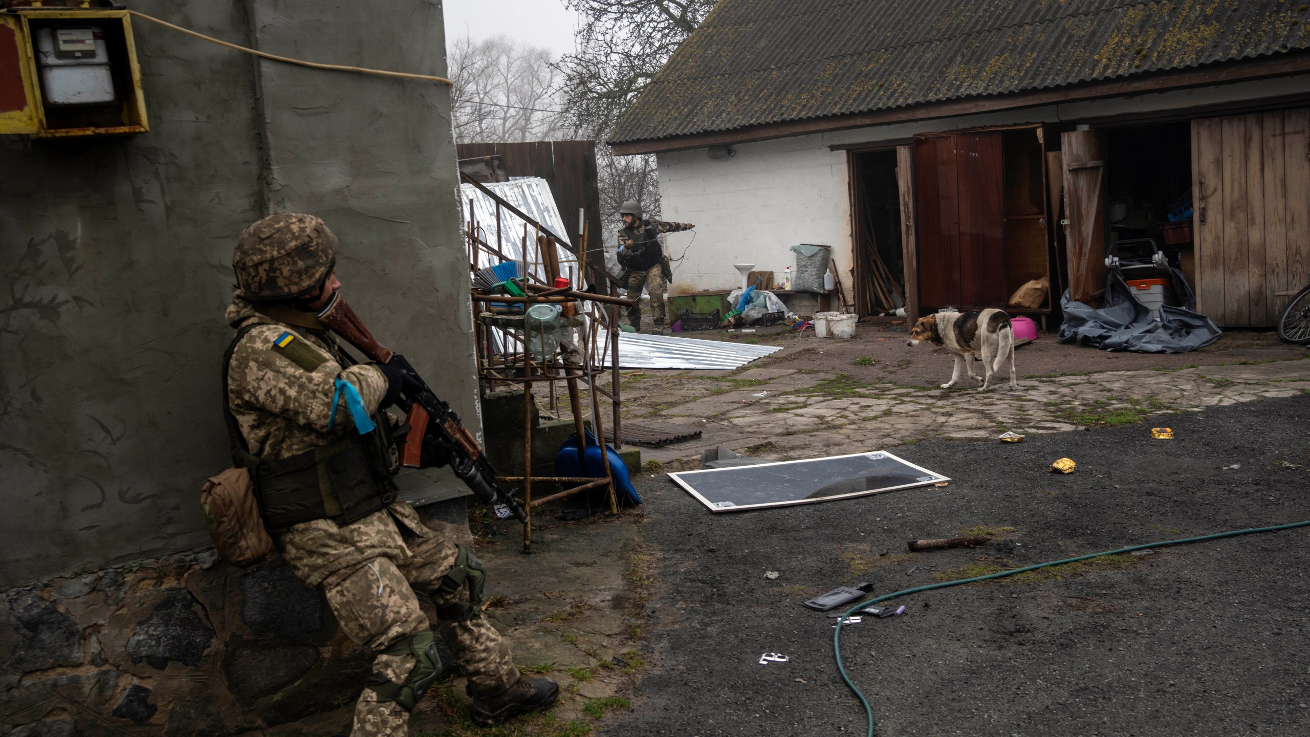 Ukrainian soldiers operate inside an abandoned house during a military sweep to search for possible remnants of Russian troops after their withdrawal from villages in the outskirts of Kyiv, Ukraine, Friday, April 1, 2022. (AP Photo/Rodrigo Abd)