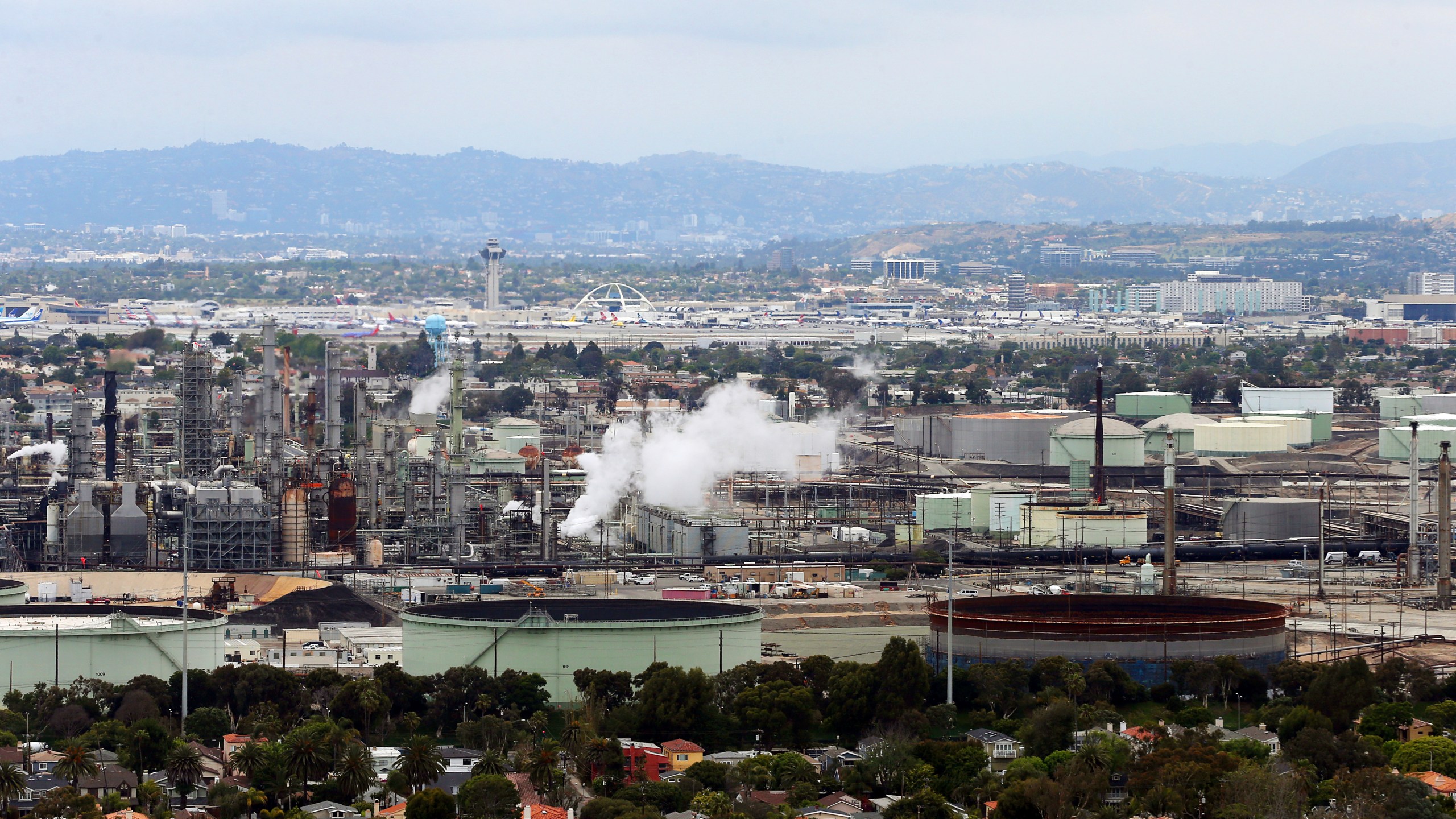 This aerial photo shows the Standard Oil Refinery in El Segundo, Calif., with Los Angeles International Airport in the background and the El Porto neighborhood of Manhattan Beach, Calif., in the foreground on May 25, 2017. A plan released by the California Air Resources Board on Tuesday, May 10, 2022, recommends a majority of the state's oil refineries install carbon capture technology by 2030. Such technology could be used to capture carbon emissions so they don't go out into the atmosphere. (AP Photo/Reed Saxon, File)