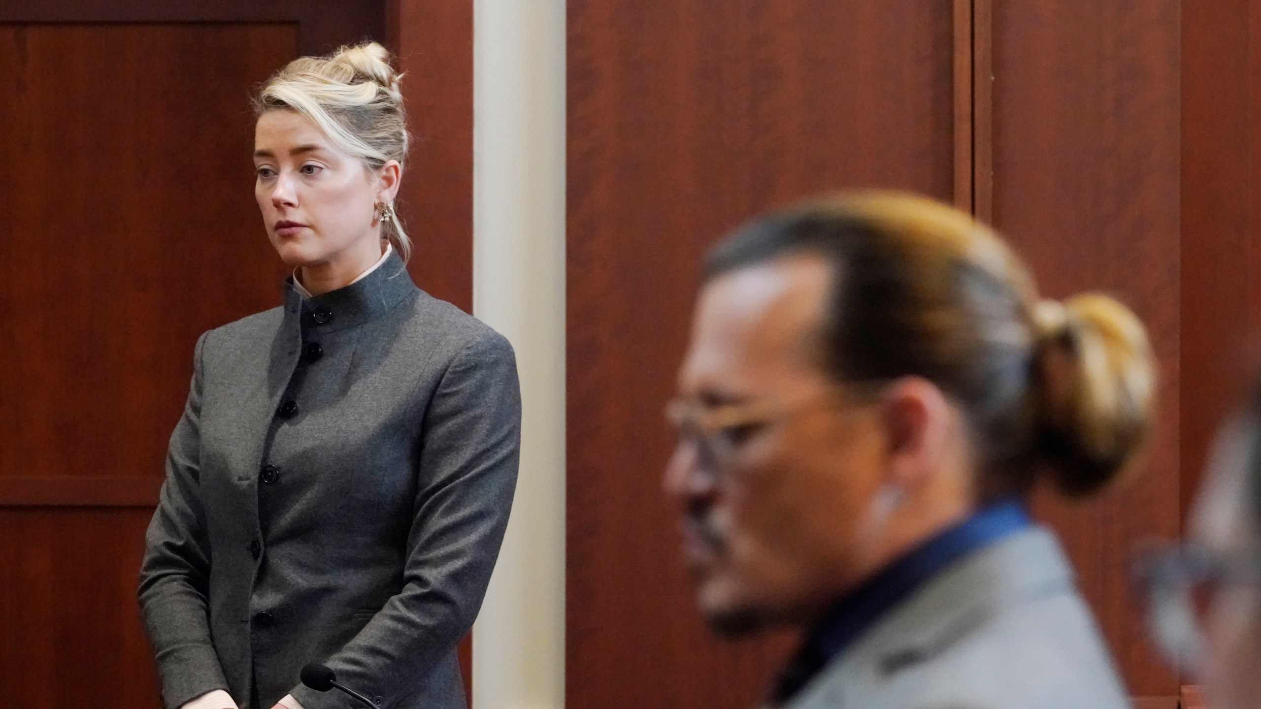 Actors Amber Heard and Johnny Depp watch as the jury leave the courtroom for a lunch break at the Fairfax County Circuit Courthouse in Fairfax, Va., Monday, May 16, 2022. Depp sued his ex-wife Heard for libel in Fairfax County Circuit Court after she wrote an op-ed piece in The Washington Post in 2018 referring to herself as a "public figure representing domestic abuse." (AP Photo/Steve Helber, Pool)