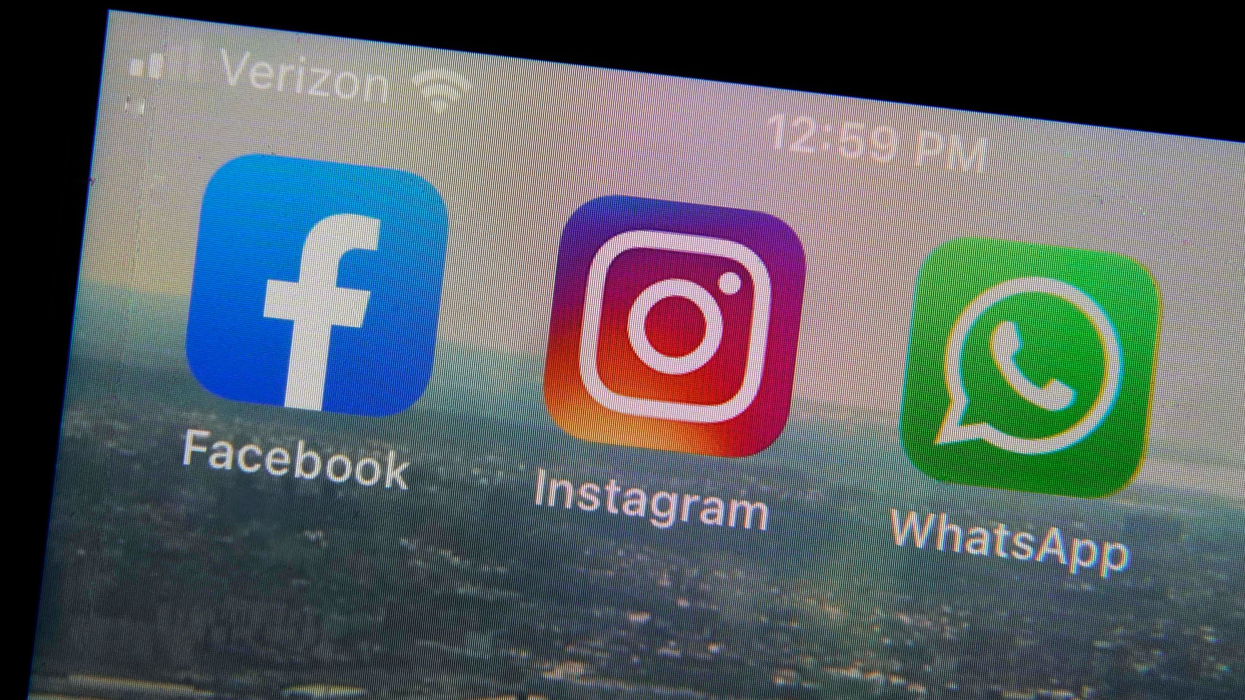 The mobile phone apps for, from left, Facebook, Instagram and WhatsApp are shown on a device in New York. The company that owns Facebook and Instagram said it will begin revealing more details about how advertisers target people with certain political ads, just months before the U.S. Midterm elections. (Richard Drew/Associated Press)