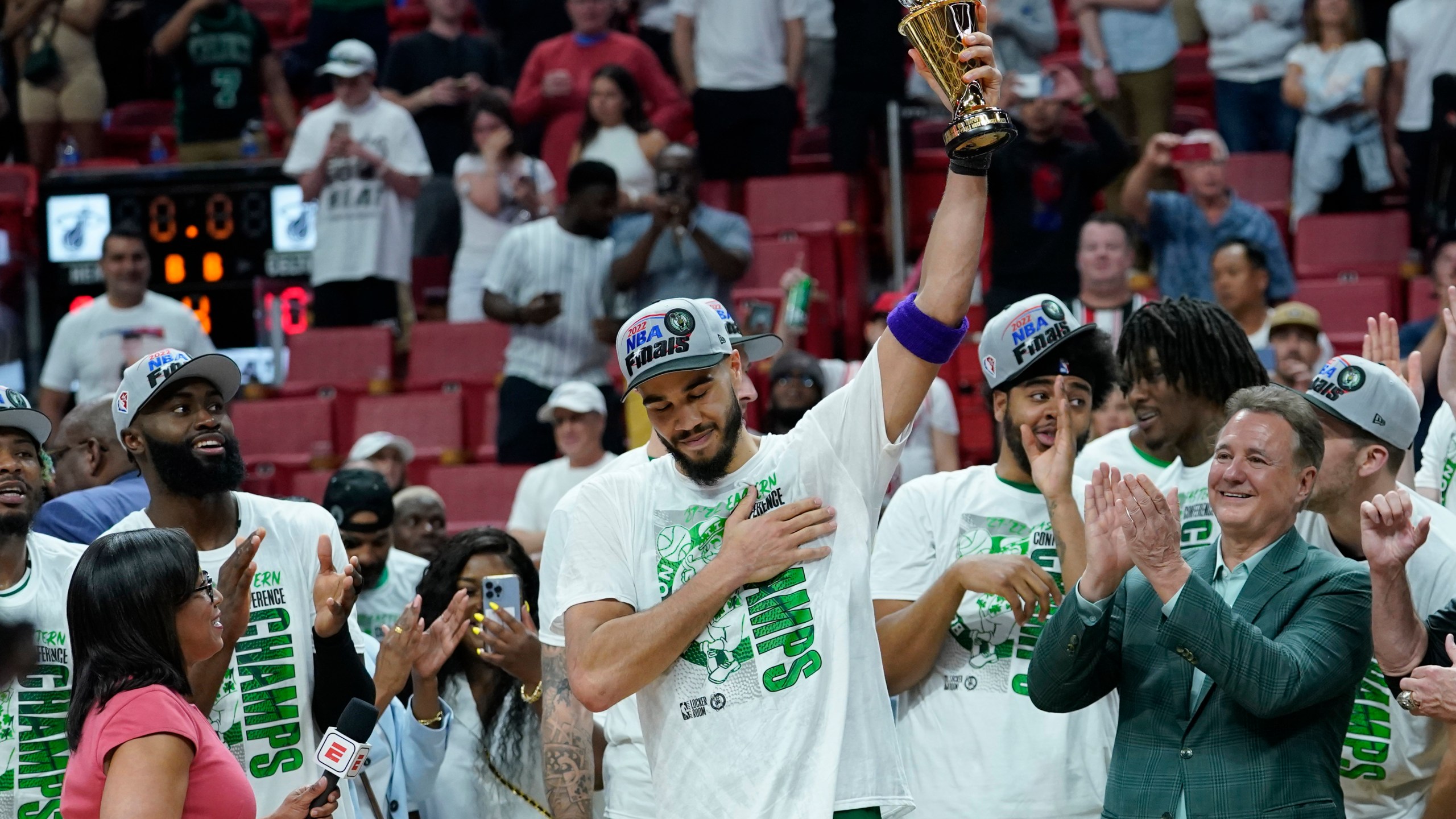 Boston Celtics forward Jayson Tatum raises the NBA Eastern Conference MVP trophy after defeating the Miami Heat in Game 7 of the NBA basketball Eastern Conference finals playoff series, Sunday, May 29, 2022, in Miami. (AP Photo/Lynne Sladky)