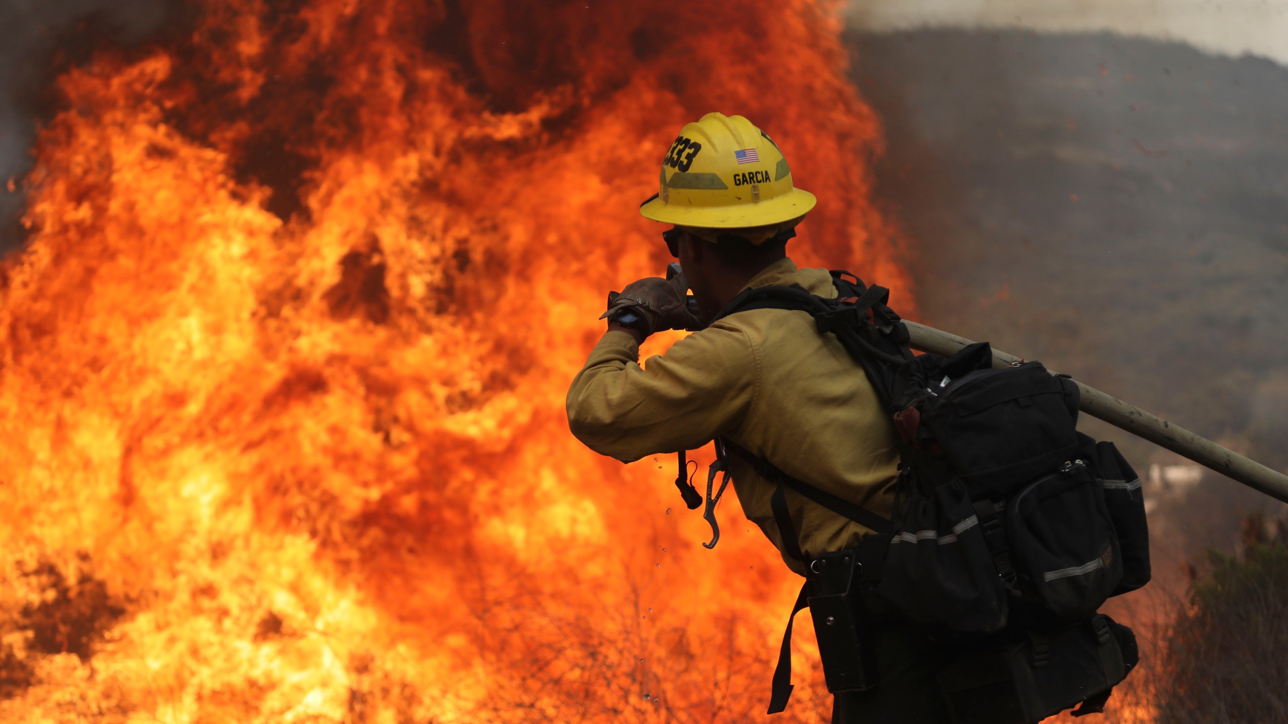 San Miguel County Firefighters battle a brush fire along Japatul Road during the Valley Fire in Jamul, California on Sept. 6, 2020. (SANDY HUFFAKER/AFP via Getty Images)