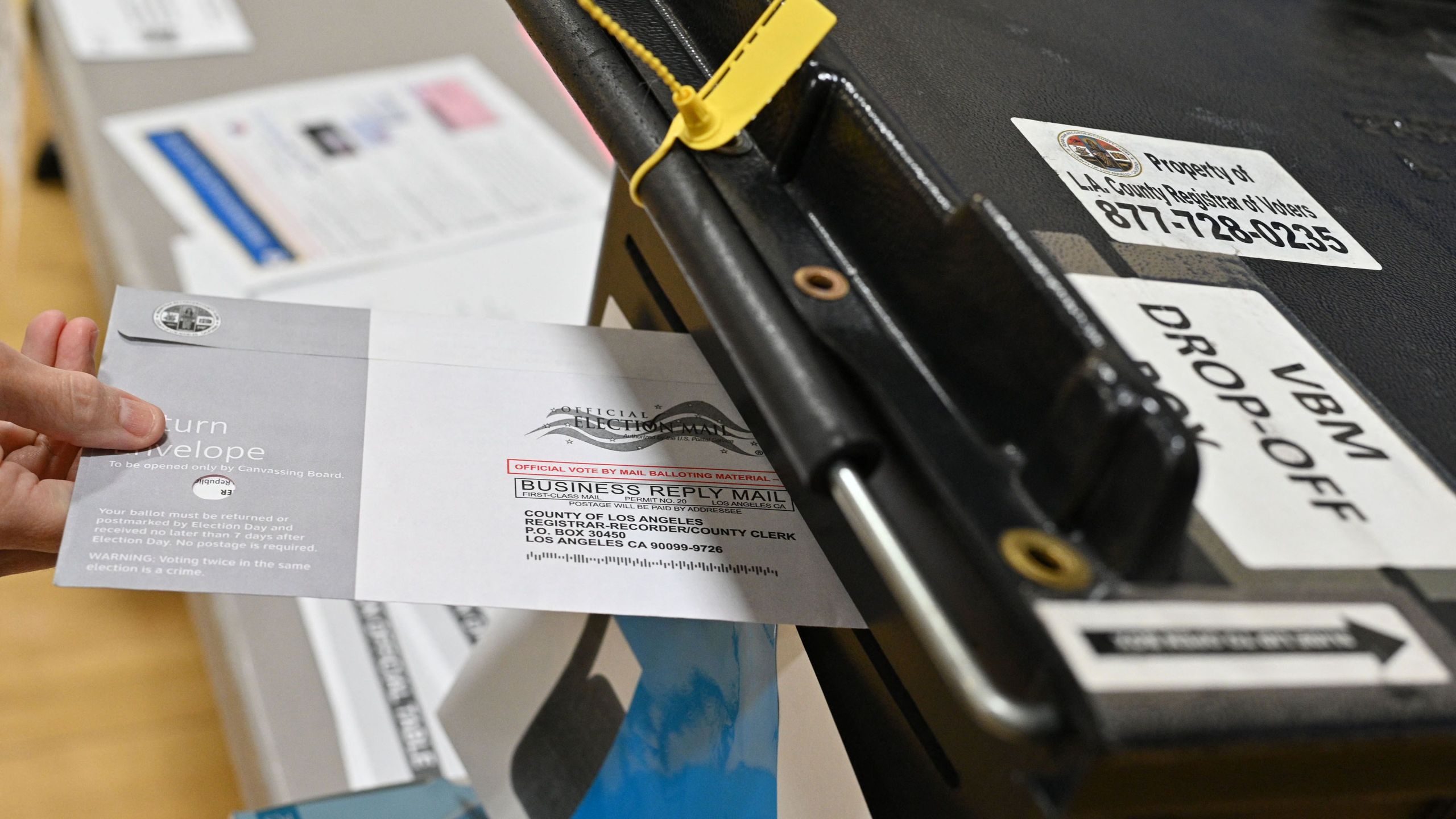 A voter drops her ballot into a ballot box in the California gubernatorial recall election at a polling station at Burbank High School in Burbank on Sept. 14, 2021. (ROBYN BECK/AFP via Getty Images)