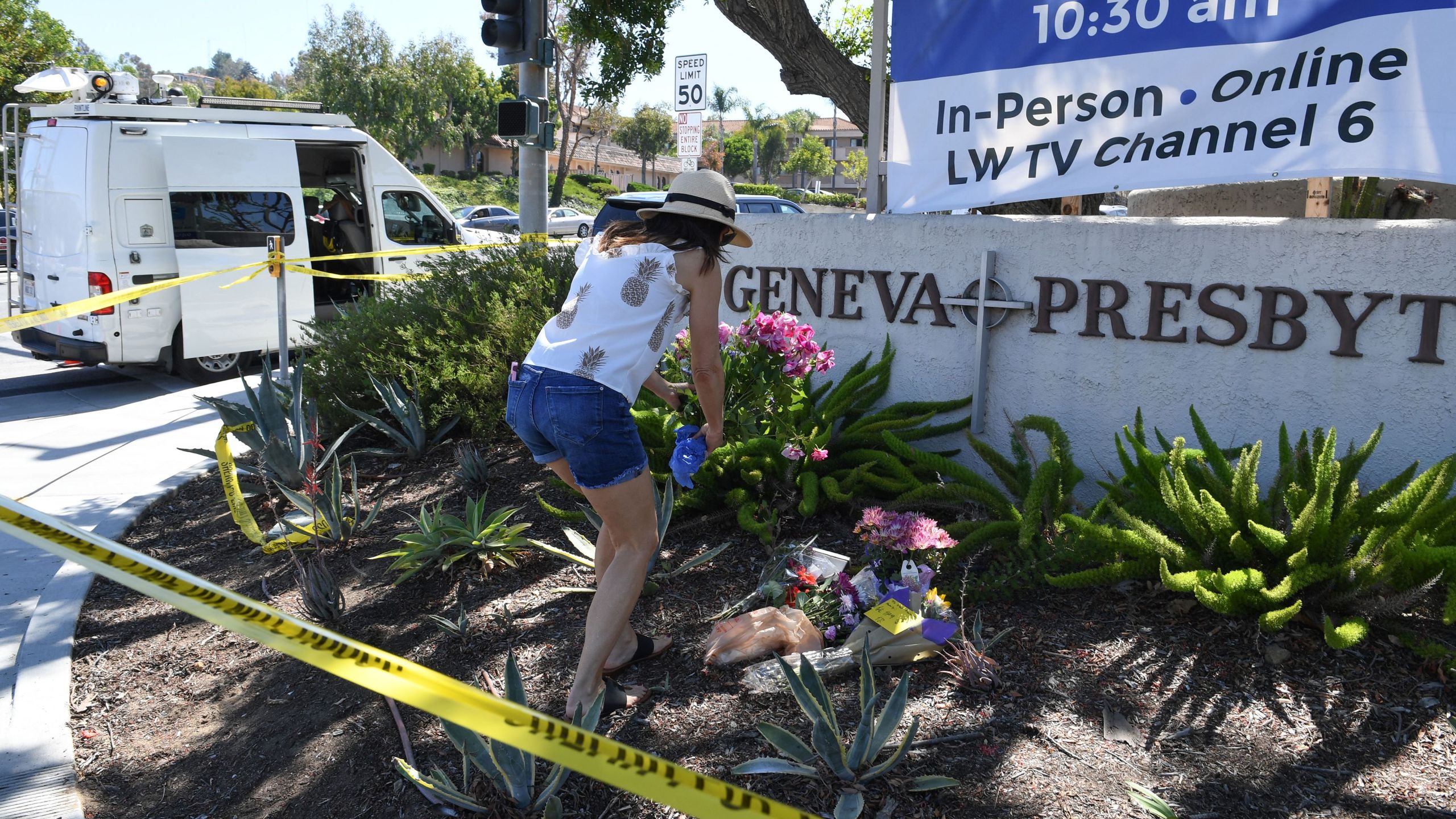 A woman places flowers at a makeshift memorial outside the Geneva Presbyterian Church May 16, 2022 after one person was killed and five injured during a shooting. (ROBYN BECK/AFP via Getty Images)