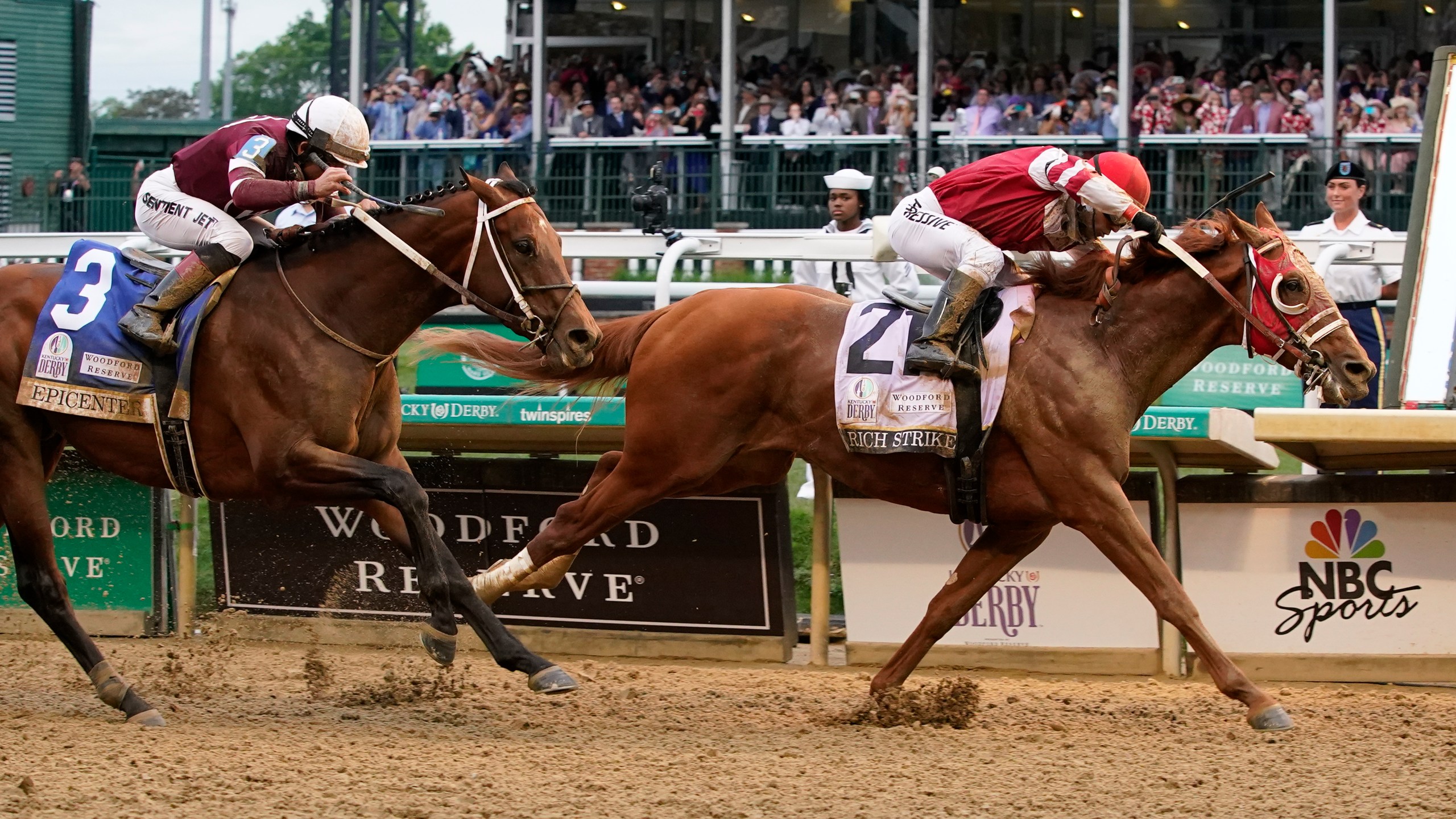 Rich Strike (21), with Sonny Leon aboard, beats Epicenter (3), with Joel Rosario aboard, at the finish line to win the 148th running of the Kentucky Derby horse race at Churchill Downs Saturday, May 7, 2022, in Louisville, Ky. (AP Photo/Mark Humphrey)