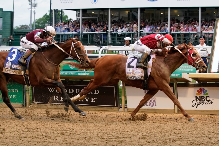 Rich Strike (21), with Sonny Leon aboard, beats Epicenter (3), with Joel Rosario aboard, at the finish line to win the 148th running of the Kentucky Derby horse race at Churchill Downs Saturday, May 7, 2022, in Louisville, Ky. (AP Photo/Mark Humphrey)