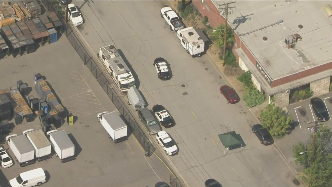 uthorities investigate the scene of a double homicide in Commerce on May 23, 2022. (KTLA)