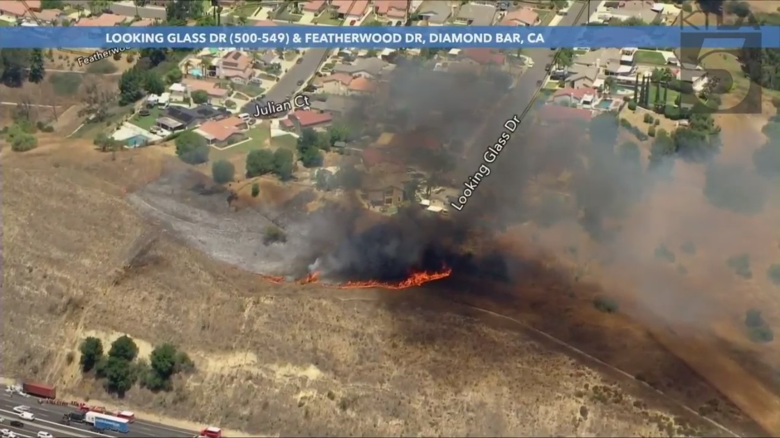 A brush fire was spreading uphill and threatening homes in the Diamond Bar area on May 23, 2022. (KTLA)