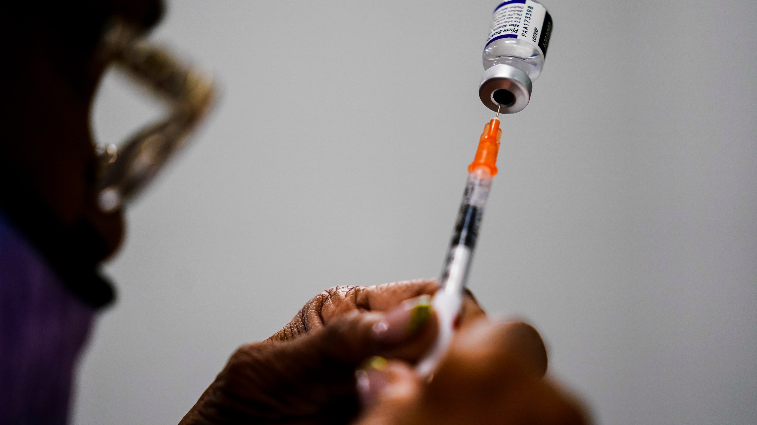 A syringe is prepared with the Pfizer COVID-19 vaccine at a vaccination clinic at the Keystone First Wellness Center in Chester, Pa., Dec. 15, 2021. (AP Photo/Matt Rourke, File)