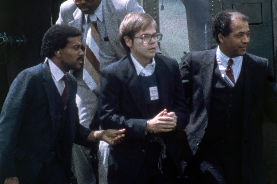 U.S. Marshals escort John Hinckley Jr. as he returns to a marine base via helicopter in Quantico, Va., Aug. 8, 1981. (Barry Thumma/Associated Press)