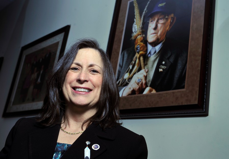 Marilynn "Lynn" Malerba stands next to a photograph of late Chief Ralph Sturges at Tribal offices in Uncasville, Conn., on March 4, 2010. Malerba, who is Native American, was nominated to be U.S. Treasurer in a historic first on June 21, 2022. (Jessica Hill/Associated Press)