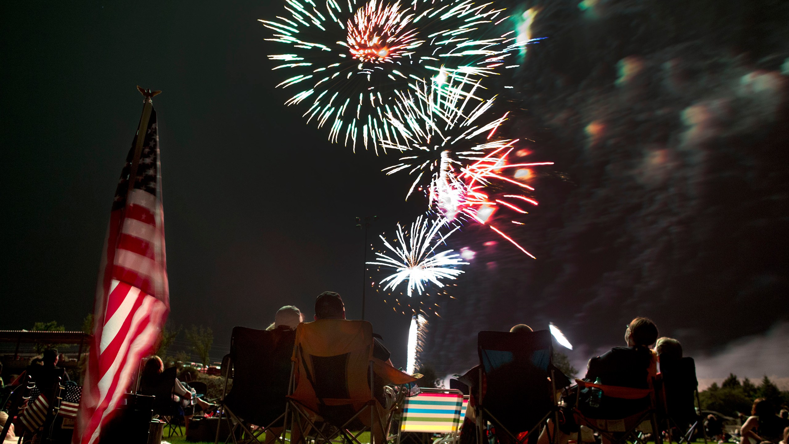 Spectators watch as fireworks explode overhead during the Fourth of July celebration at Pioneer Park, on July 4, 2013, in Prescott, Ariz. The skies over a scattering of Western cities will stay dark for the third consecutive Fourth of July in 2022 as some big fireworks displays are canceled again, this time for pandemic related supply chain or staffing problems, or fire concerns amid dry weather. The city of Phoenix cited supply chain issues in canceling its three major Independence Day fireworks shows. (AP Photo/Julie Jacobson, File)