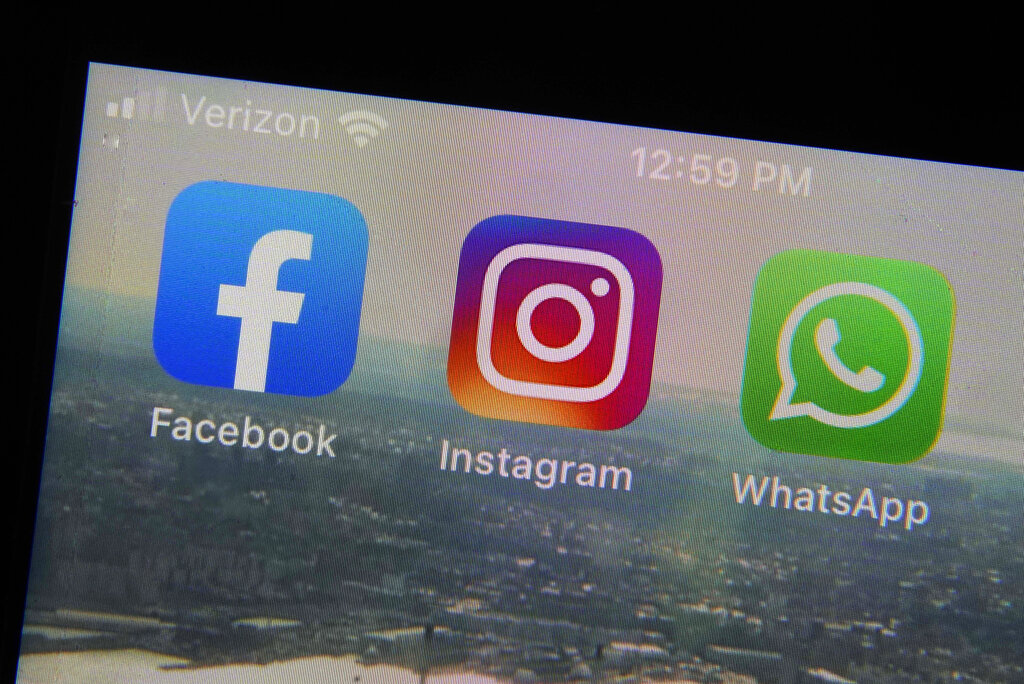 The mobile phone apps for, from left, Facebook, Instagram and WhatsApp are shown on a device in New York. (Richard Drew/Associated Press)