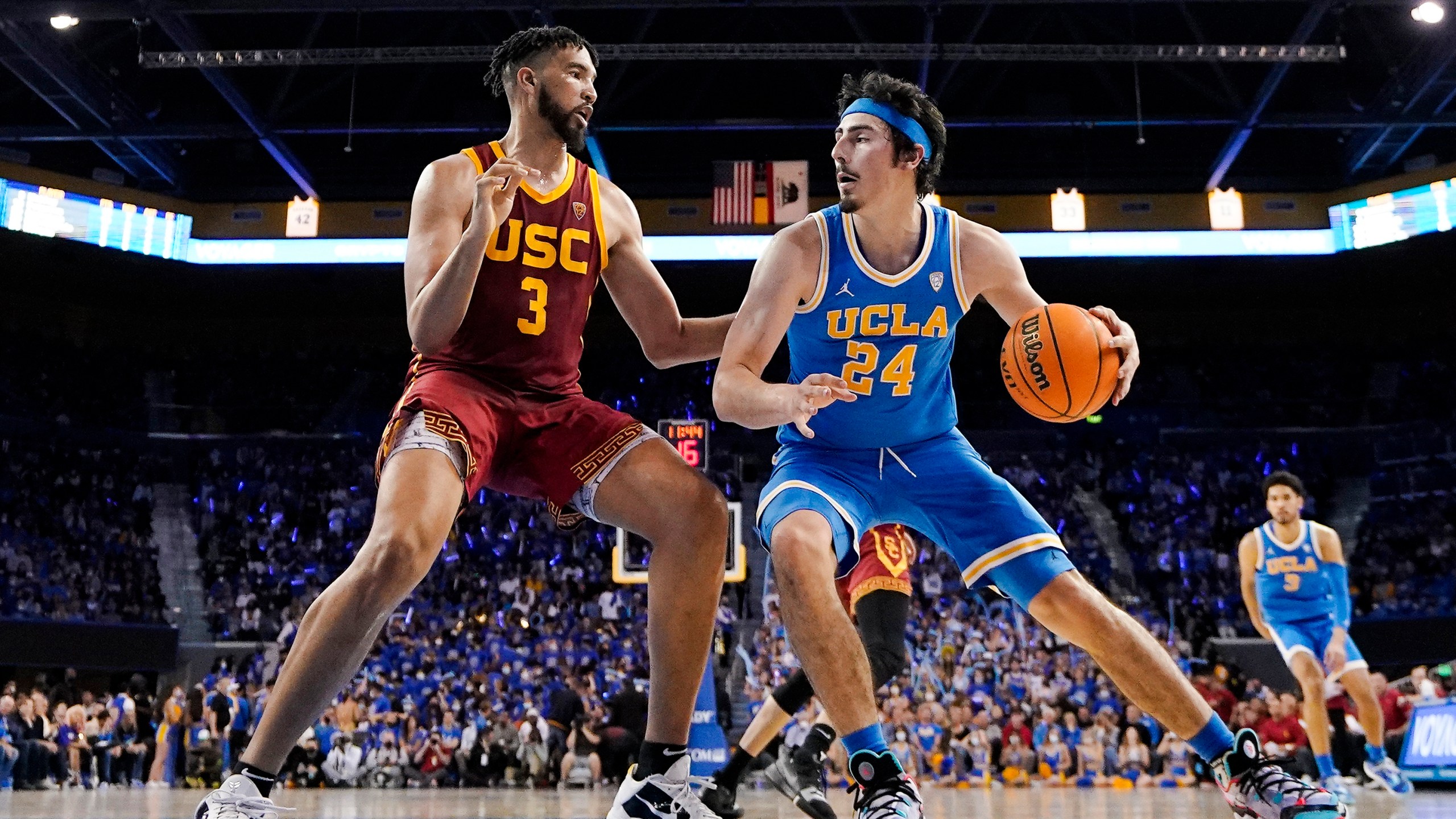 UCLA guard Jaime Jaquez Jr., right, tries to get by Southern California forward Isaiah Mobley during the second half of an NCAA college basketball game on March 5, 2022, in Los Angeles. UCLA and Southern California are planning to leave the Pac-12 for the Big Ten Conference in a seismic change that could lead to another major realignment of college sports. (AP Photo/Mark J. Terrill, File)