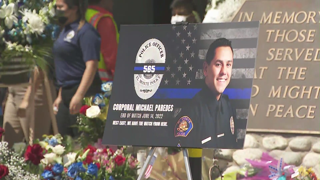 A photo of Corporal Michael Paredes is seen outside the El Monte Police Department on June 15, 2022, a day after he was shot and killed while responding to a reported stabbing with a fellow officer. (KTLA)