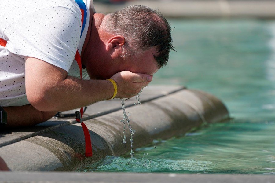 A man refreshes his face at a fountain in Trafalgar Square in central London on July 19, 2022. Britain shattered its record for highest temperature ever registered Tuesday, with a provisional reading of 39.1 degrees Celsius (102.4 degrees Fahrenheit), according to the country's weather office — and the heat was only expected to rise. (Aaron Chown/PA Wire/PA via AP)