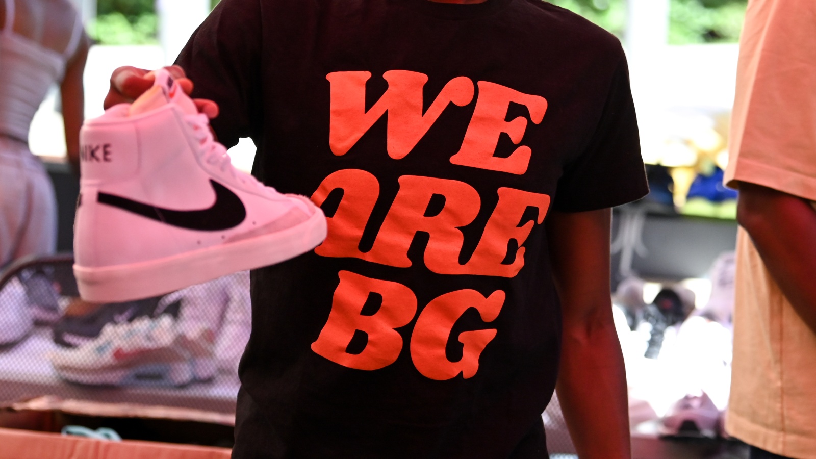 Sparks guard Brittney Sykes holds a Nike shoe while wearing a shirt to honor Brittney Griner during a shoe drive in Los Angeles on July 18, 2022 (Los Angeles Sparks)