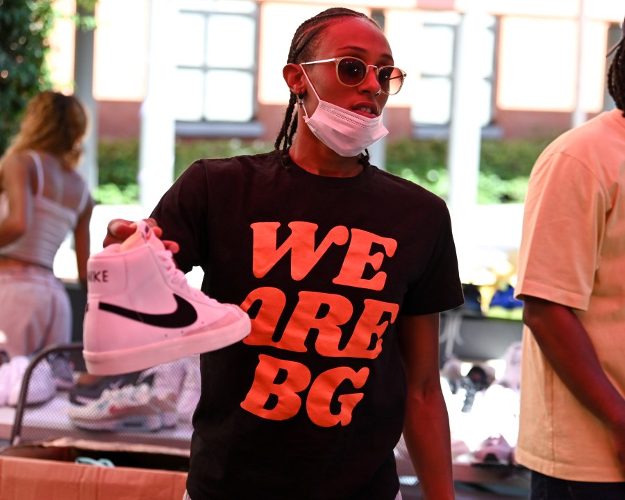 Sparks guard Brittney Sykes holds a Nike shoe while wearing a shirt to honor Brittney Griner during a shoe drive in Los Angeles on July 18, 2022 (Los Angeles Sparks)