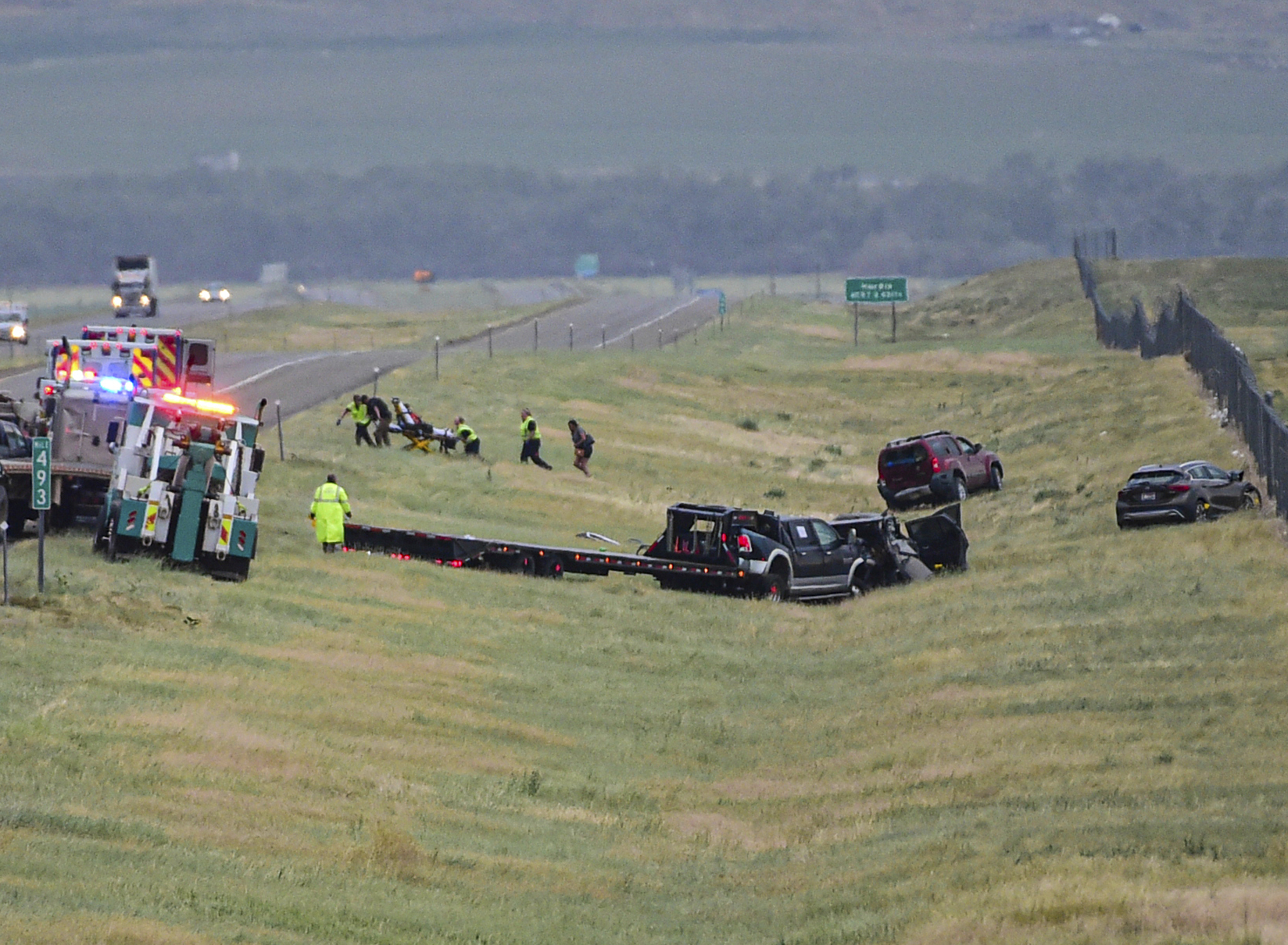 First responders work the scene on Interstate 90 after a fatal pileup where at least 20 vehicles crashed near Hardin, Mont., Friday, July 15, 2022. (Amy Lynn Nelson/The Billings Gazette via AP)