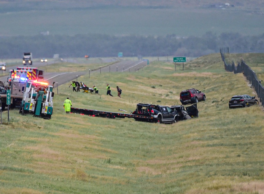 First responders work the scene on Interstate 90 after a fatal pileup where at least 20 vehicles crashed near Hardin, Mont., Friday, July 15, 2022. (Amy Lynn Nelson/The Billings Gazette via AP)