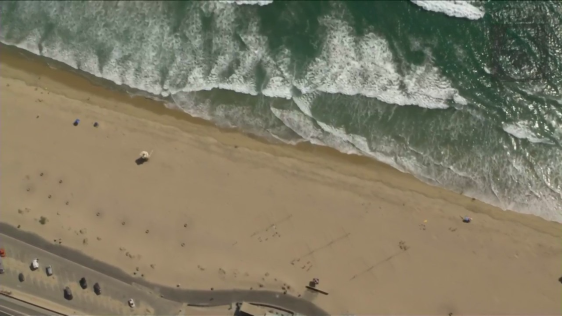 A portion of the Huntington Beach coast was briefly closed on July 18, 2022 after a reported shark sighting. (KTLA)